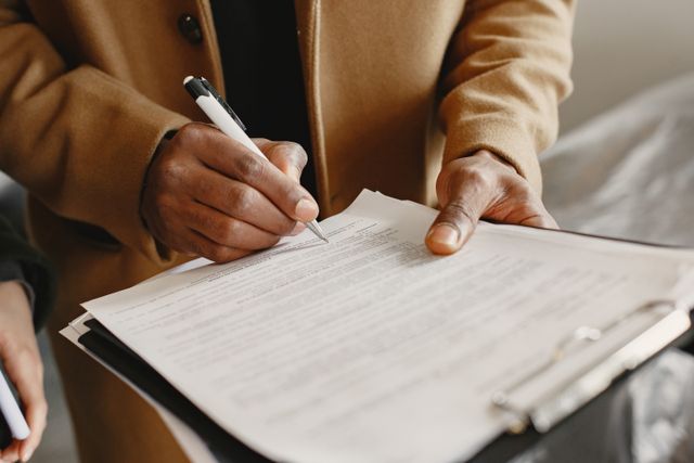 A%20person%20signing%20a%20document